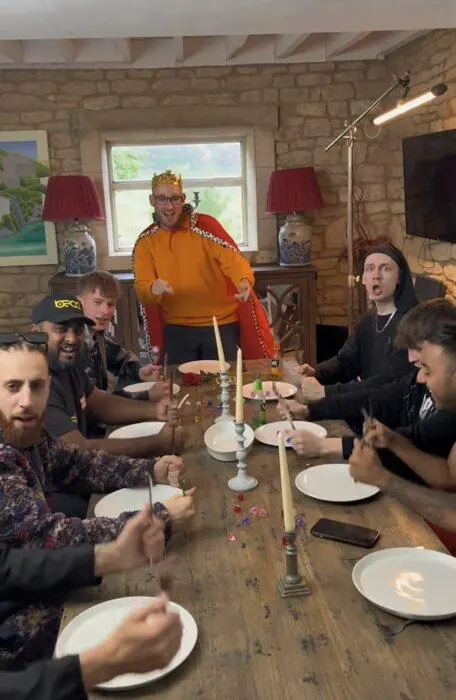 TikSquad filming a medieval-themed scene around a long table.