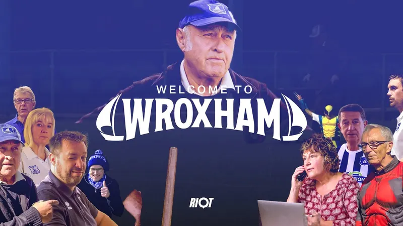 Welcome to Wroxham trailer title, with Wroxham FC players and fans around it.